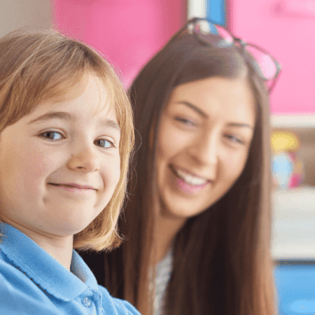 Girl in school uniform completing Reception baseline assessment with teacher