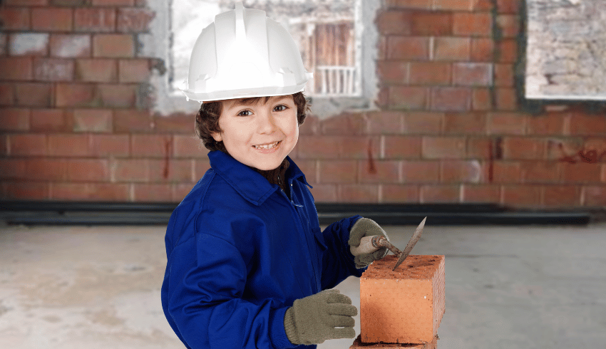 Young child trying bricklaying, representing firsthand experiences