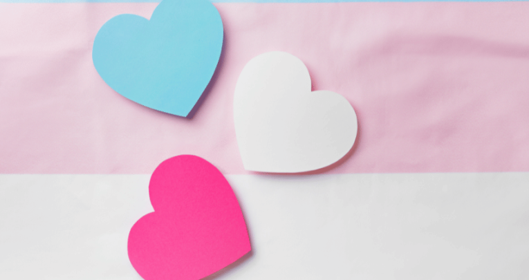 Blue, white and pink hearts representing trans children