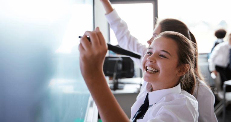 Girl playing GCSE maths games on smart board