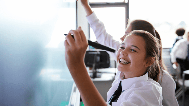 Girl playing GCSE maths games on smart board