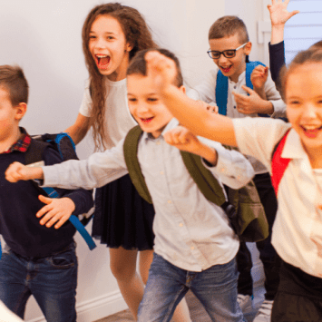 Schoolchildren in uniform looking happy, representing friendship activities