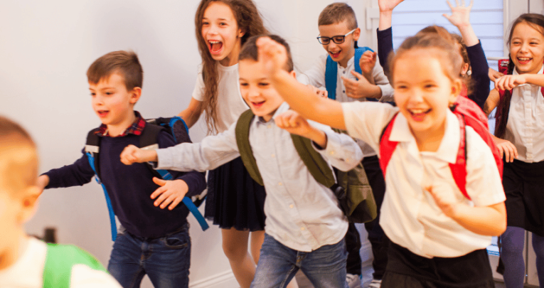 Schoolchildren in uniform looking happy for International Friendship Day