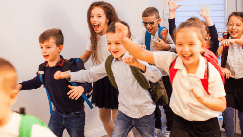 Schoolchildren in uniform looking happy for International Friendship Day