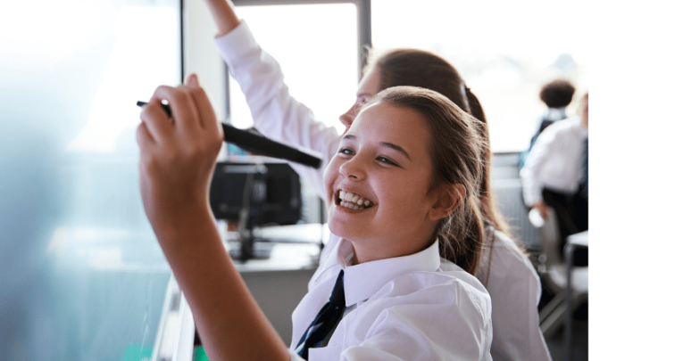 Schoolgirl doing KS3 maths on board