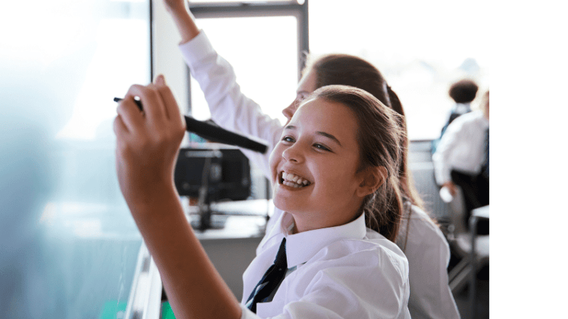 Schoolgirl doing KS3 maths on board