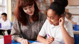 SENCO teacher sitting with smiling student