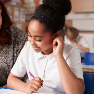 SENCO teacher sitting with smiling student