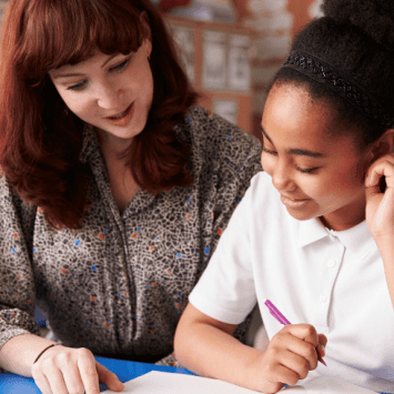 SENCO teacher sitting with smiling student
