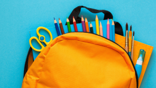 School supplies in yellow backpack