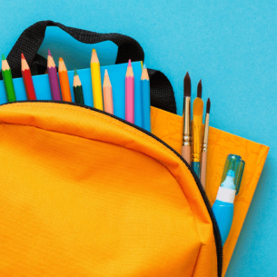 School supplies in yellow backpack