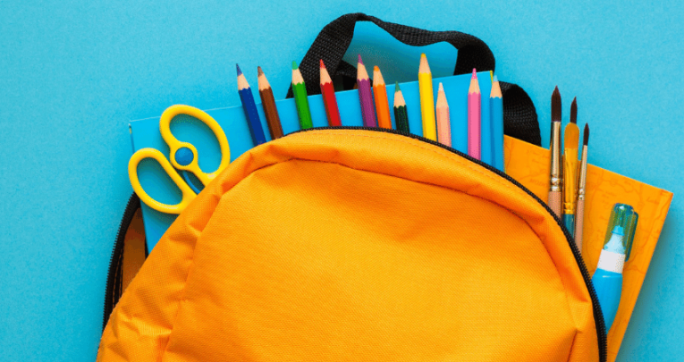 School supplies in yellow backpack