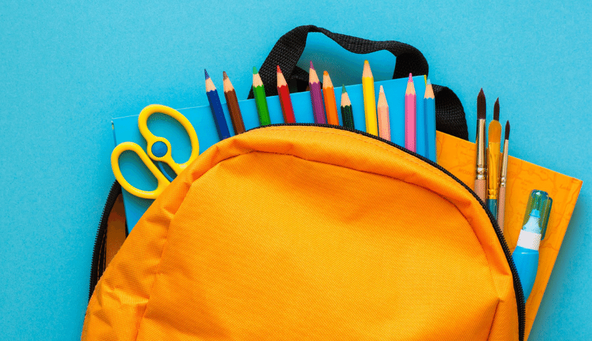 School supplies in yellow backpack