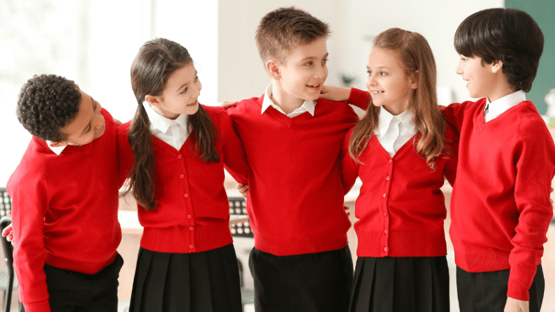 Schoolchildren in uniform doing icebreaker games