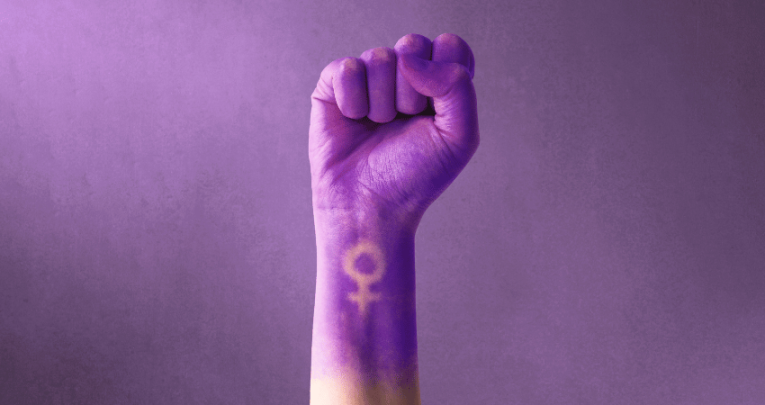 Fist painted purple, with feminine symbol, representing International Women's Day