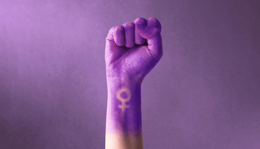 Fist painted purple, with feminine symbol, representing International Women's Day