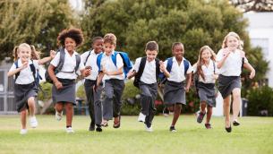 Primary school pupils running outside