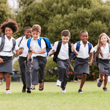 Primary school pupils running outside