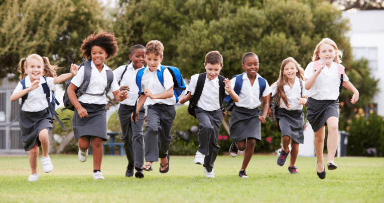 Primary school pupils running outside