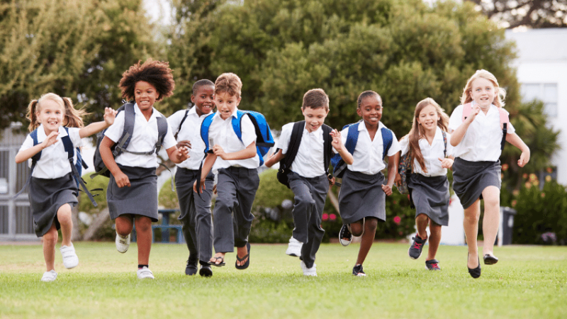 Primary school pupils running outside