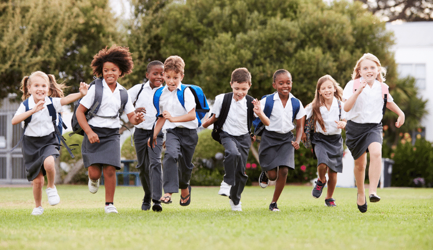 Primary school pupils running outside