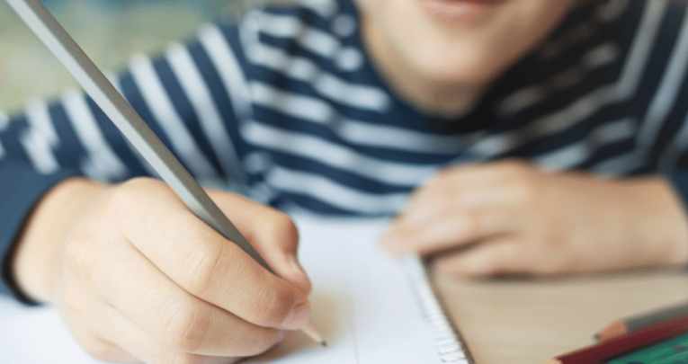 Kid doing greater depth writing in a notebook