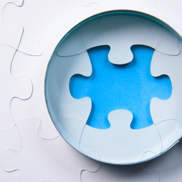 Magnifying glass on missing puzzle piece, epresenting Intent, Implementation, Impact element of Ofsted inspections