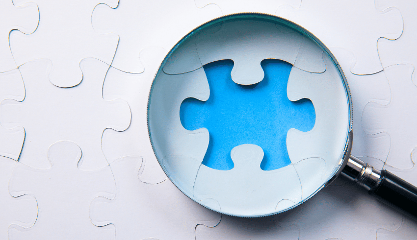 Magnifying glass on missing puzzle piece, epresenting Intent, Implementation, Impact element of Ofsted inspections
