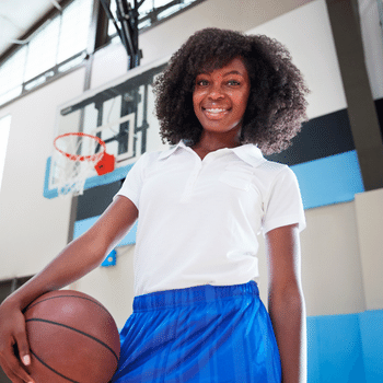 School girl playing basketball