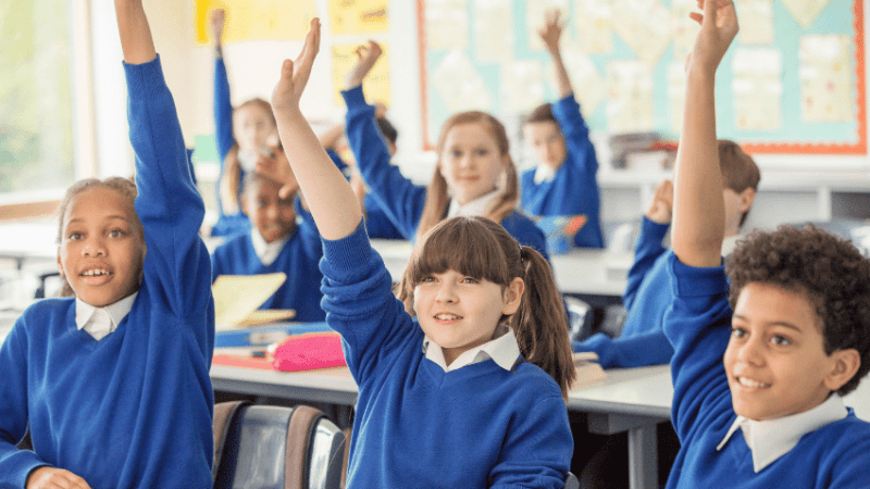 Schoolchildren raising their hands, representing working memory