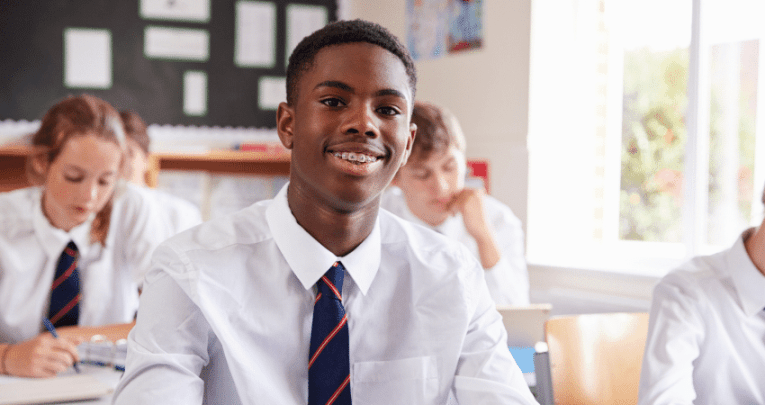 Teenage boy in classroom at desk