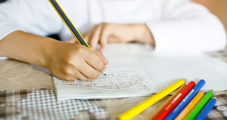 Child writing, representing National Writing Day