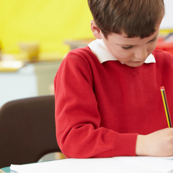 Schoolboy writing sentence openers