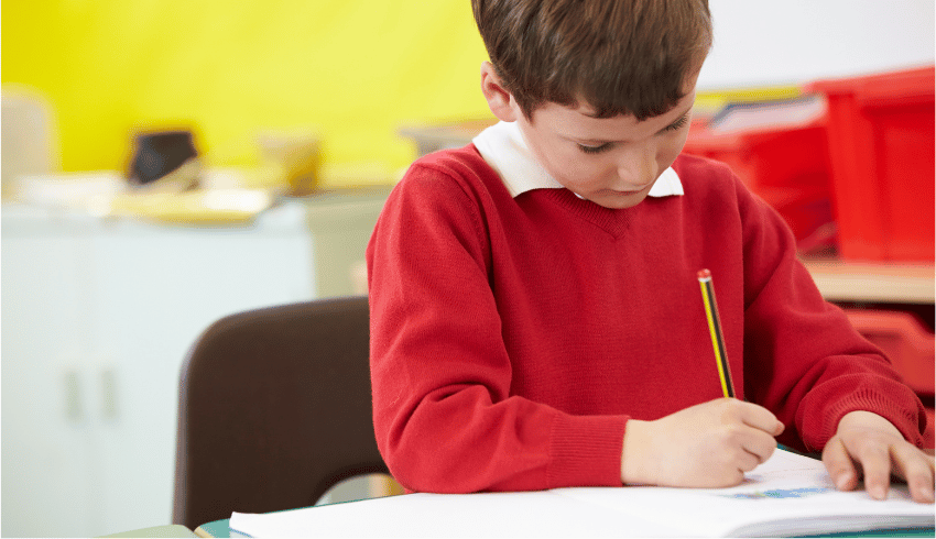 Schoolboy writing sentence openers