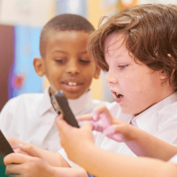 Children in school uniform doing collaborative learning