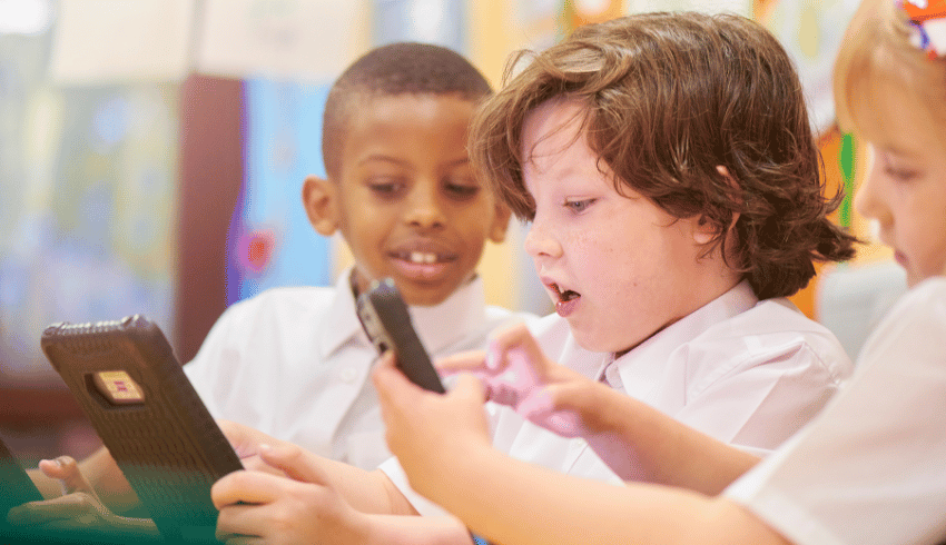 Children in school uniform doing collaborative learning