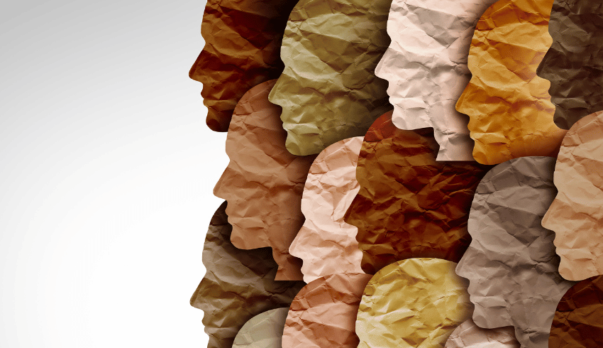 Overlapping face shapes made from different coloured paper, representing diversity in schools
