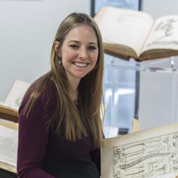 Professor Alice Roberts holding an old book