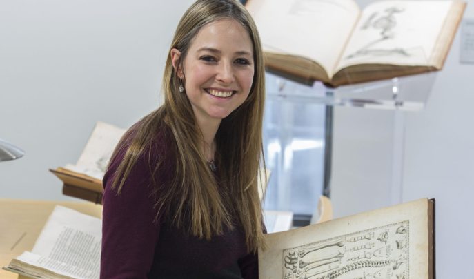 Professor Alice Roberts holding an old book