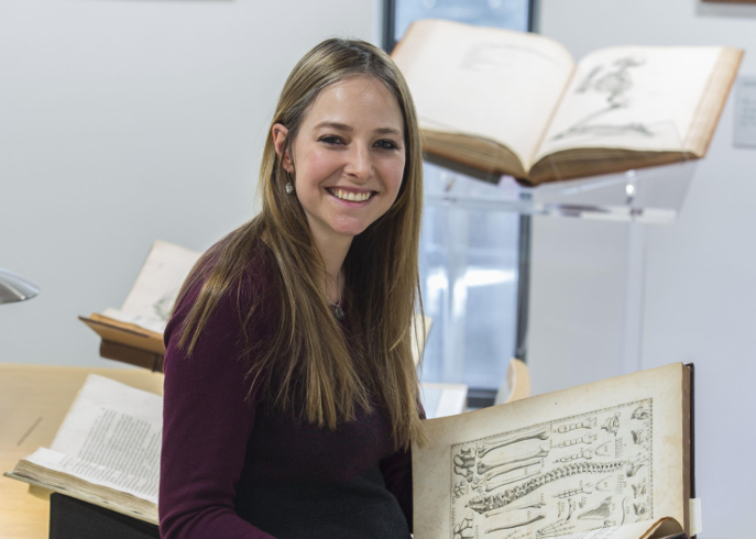 Professor Alice Roberts holding an old book
