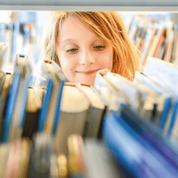 Child browsing school library