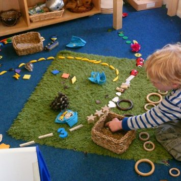 Boy in Early Years creating transient art