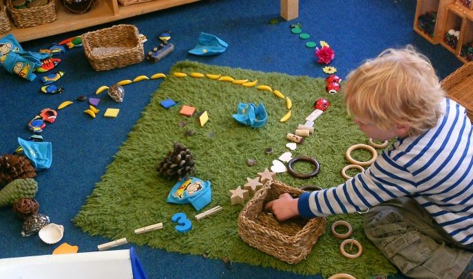 Boy in Early Years creating transient art