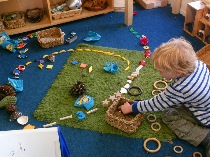 Boy in Early Years creating transient art