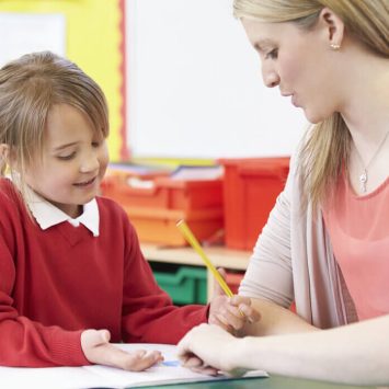 Child and teacher in classroom doing SPaG