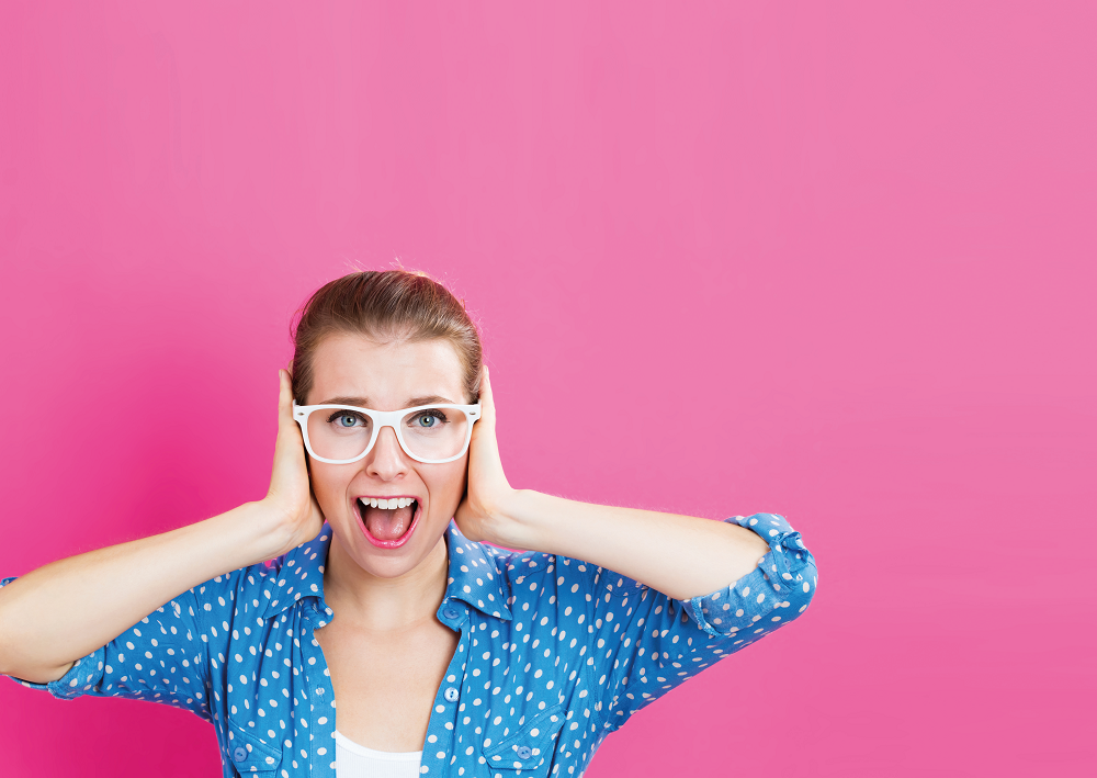 Teacher covering ears, representing behaviour management strategies for primary school