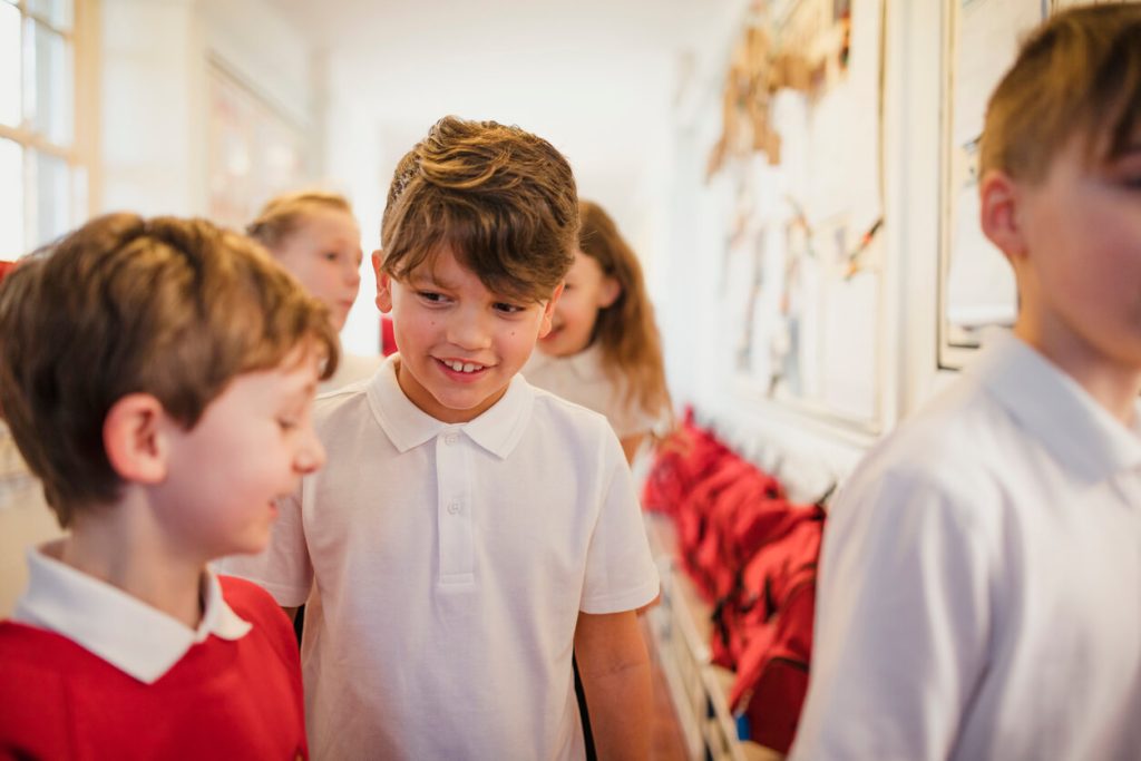 Primary children talking in corridor