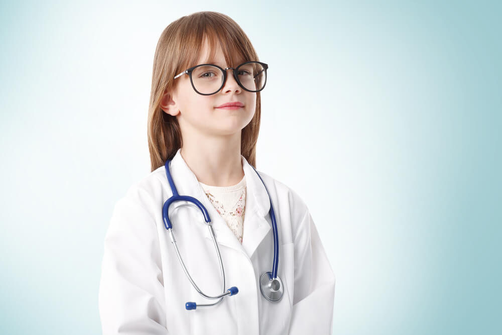 Young girl wearing oversized doctor outfit