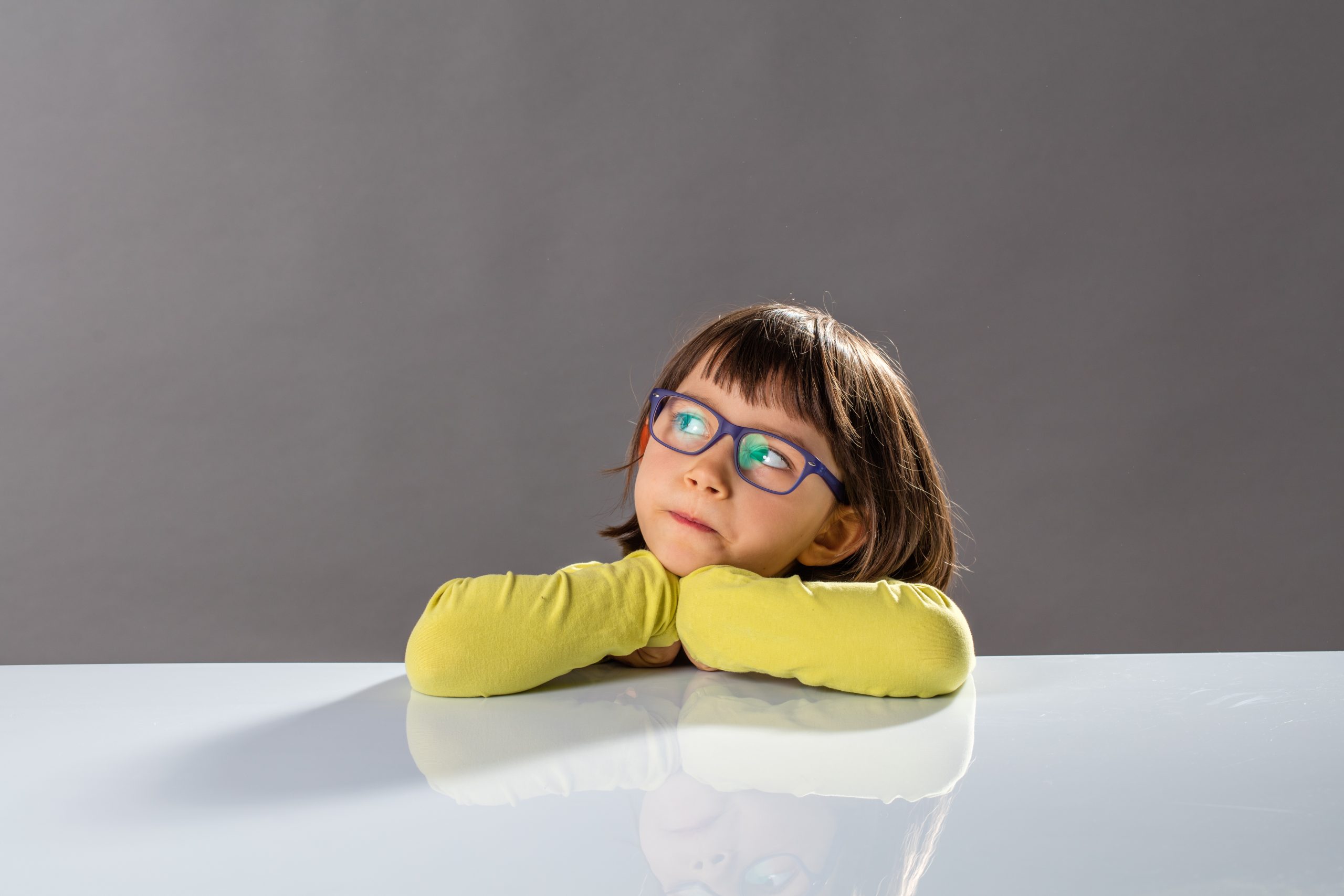Small girl looking thoughtful, representing critical thinking