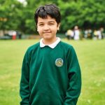 Young boy in school uniform smiling